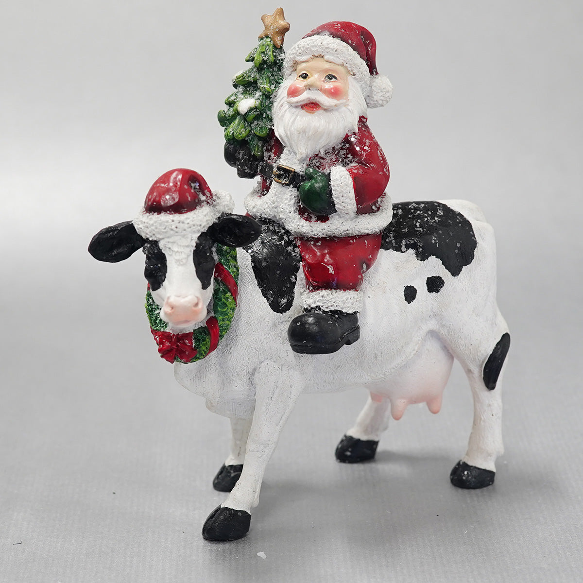 Santa Sitting On Cow