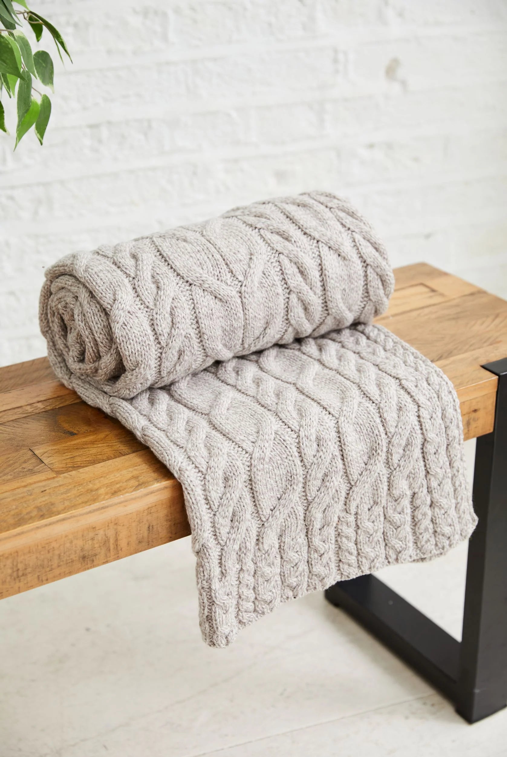Aran Woollen Mills Silver Strand Supersoft Aran Cable 100% Merino wool Throw in Oatmeal, showing stitch details.