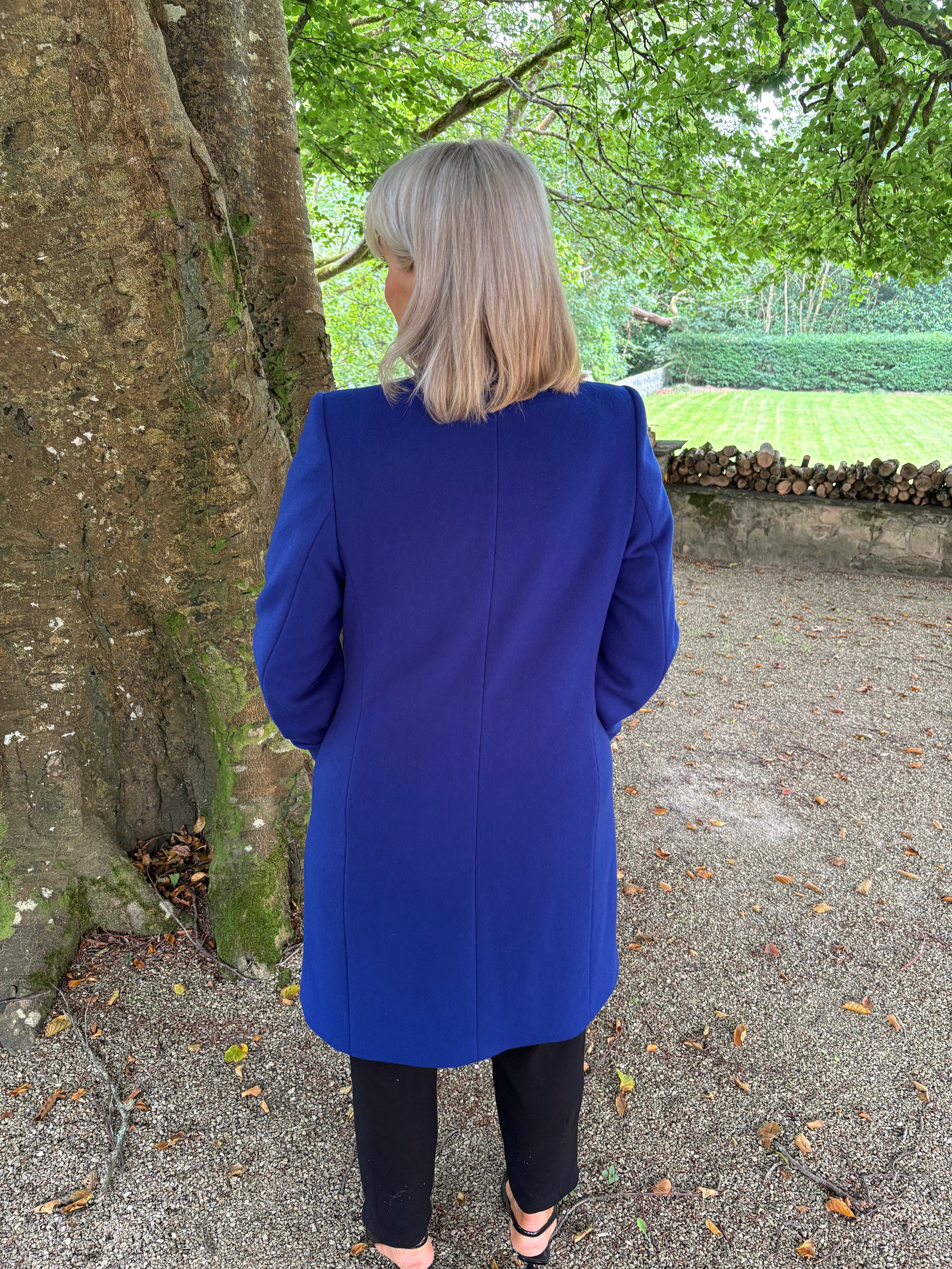 Christina Felix blue wool coat. Photo shot outdoors.
