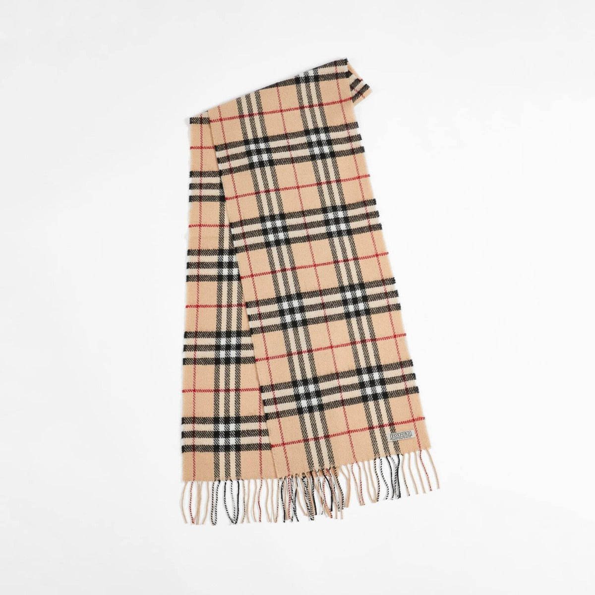 Model wearing Foxford Woollen Mills fawn check lambswool scarf