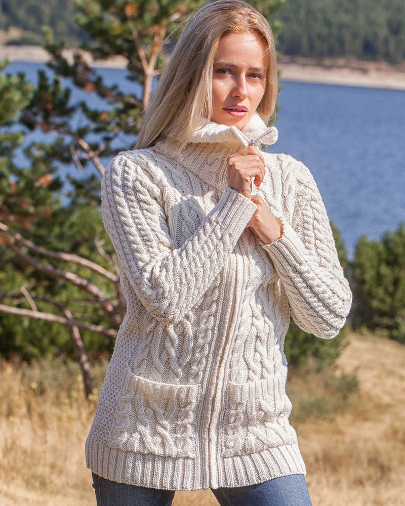 Model wearing long Aran full-zip sweater in natural