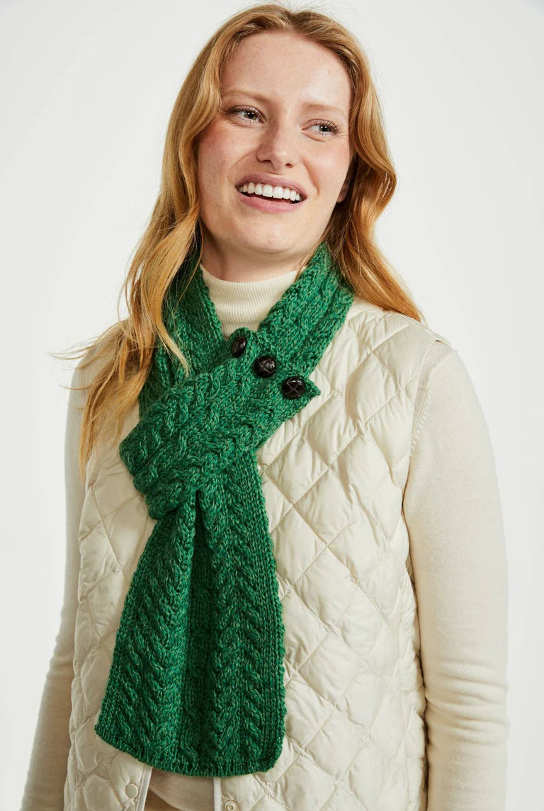 Model wearing Aran Woollen Mills Ballina Aran Buttoned Loop Scarf in Kiwi Green, 100% Merino Wool, made in Ireland