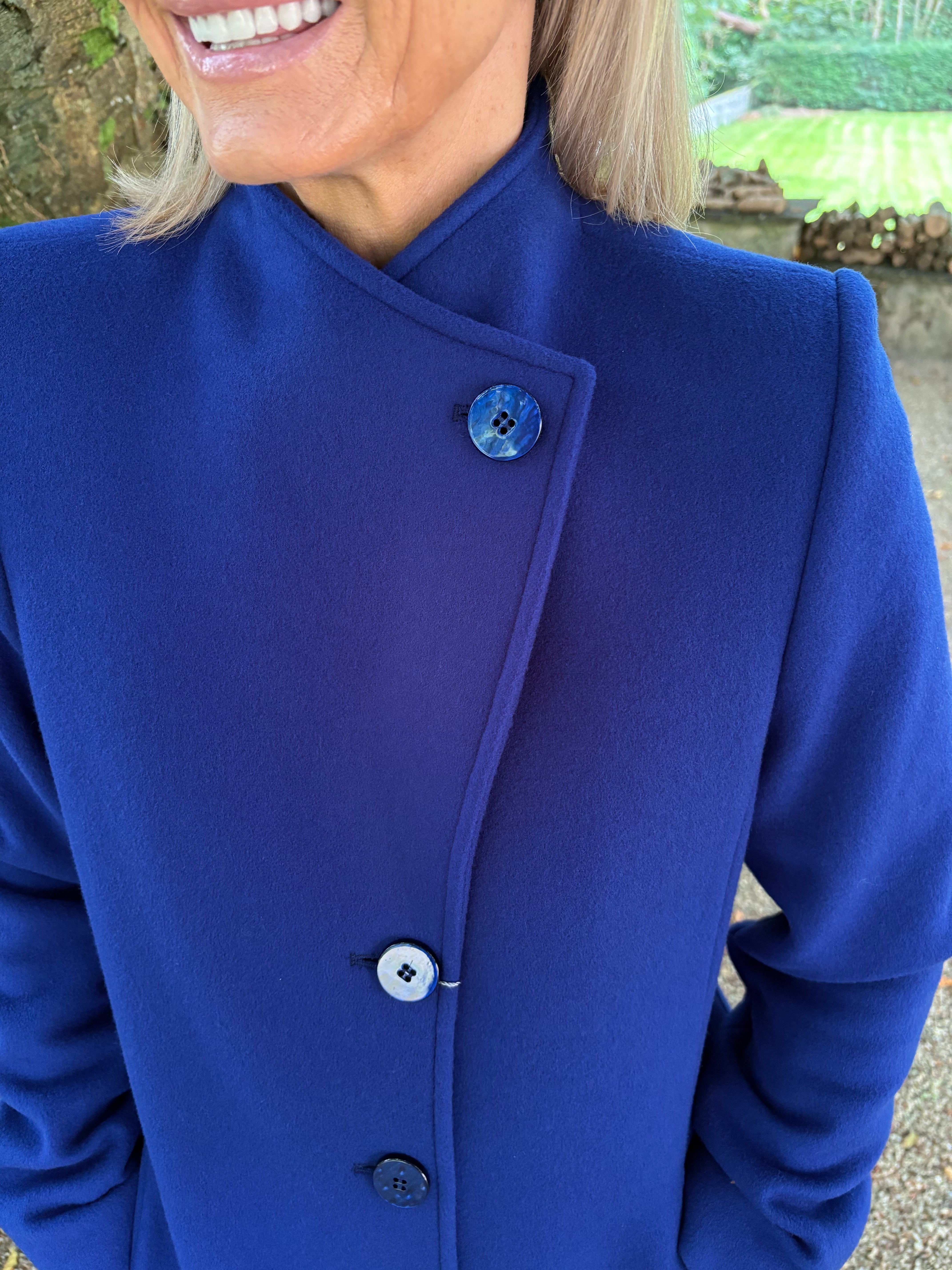 Close up of Christina Feliz wool cashmere blend coat. Collar and button detail.