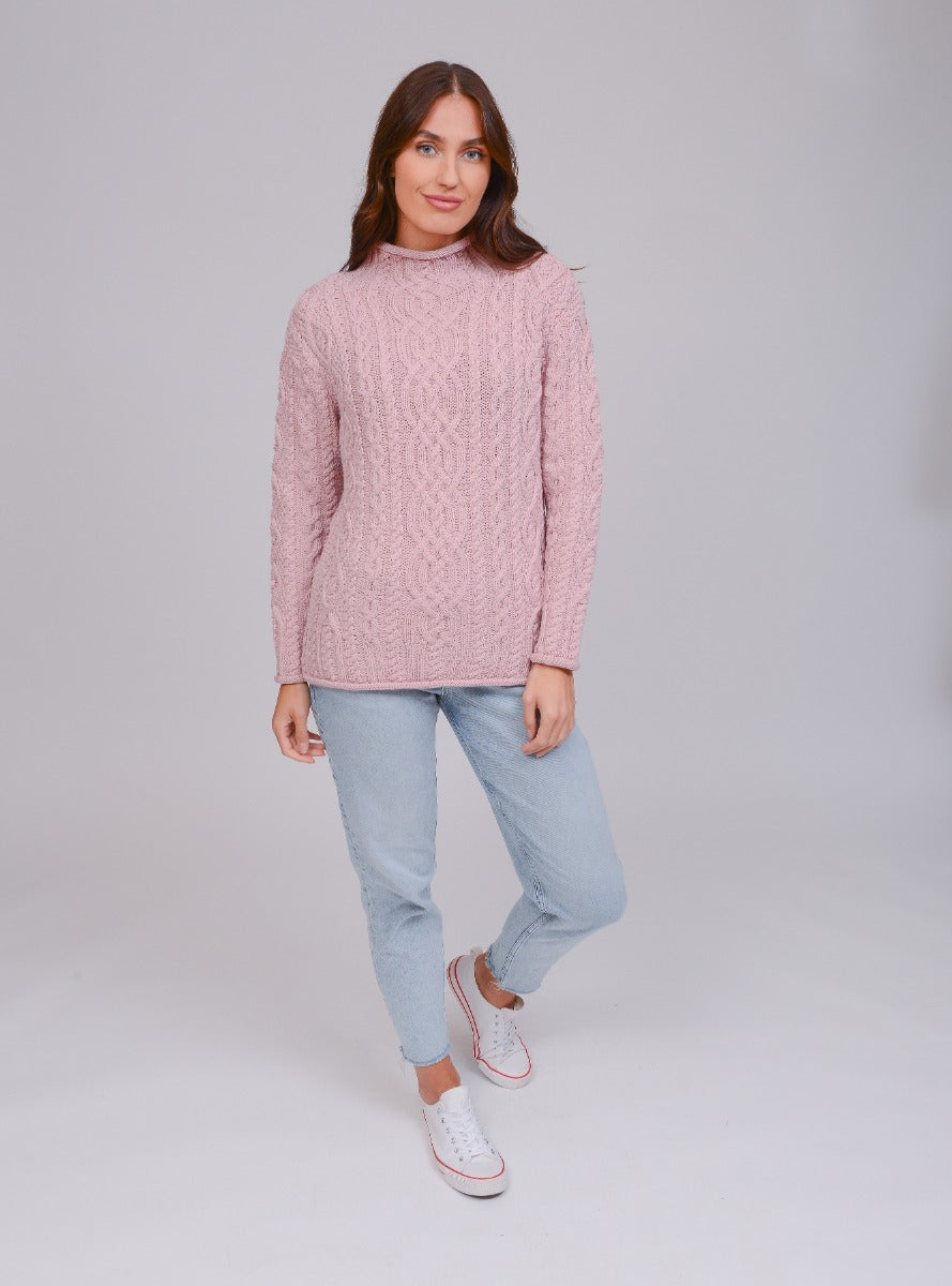 Model wearing a supersoft Aran sweater in dusty pink
